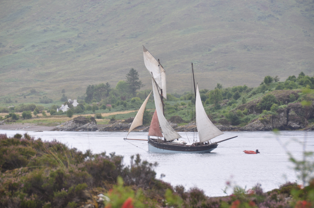old-style yacht under fulll sail heading west in the narrows