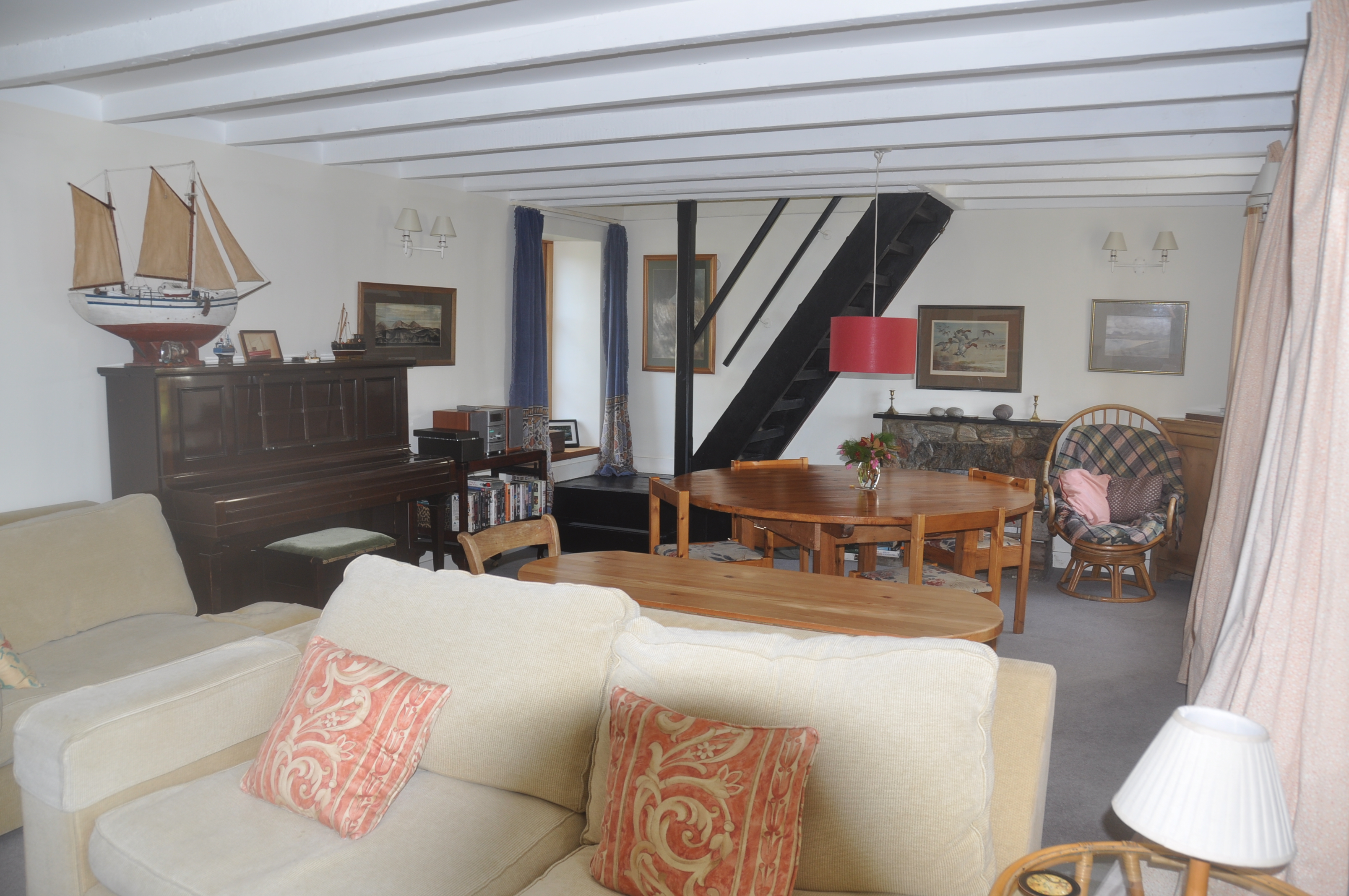 other end of sitting room with piano and dining area